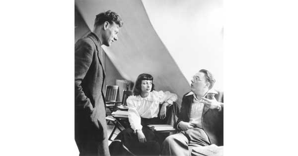 Paul de Man (at left) talking with Renée and Ted Weiss, editors of the Quarterly Review of Literature, in December 1949 (Bard College Library Archives/Hamilton Winslow)