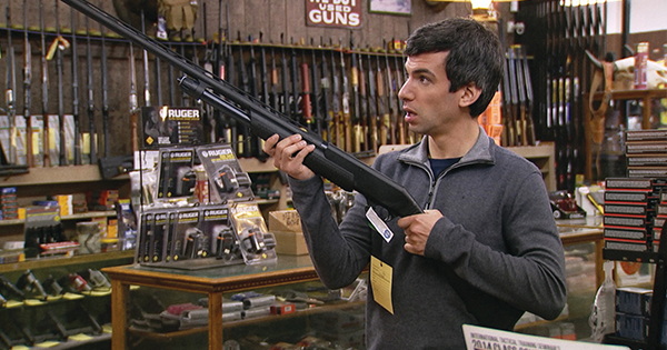 Nathan’s quest for a way to allow overweight people to go horseback riding takes him to a gun shop. (Comedy Central/Everett Collection)