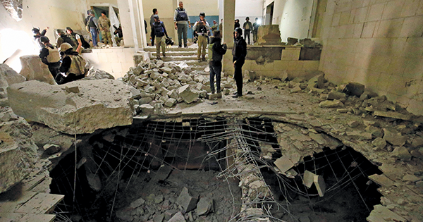 Assessing the damage to the Mosul Museum after it was retaken this spring. In this room in 2015, ISIS fighters smashed artifacts with sledgehammers. (Reuters/ Alamy Stock Photo)