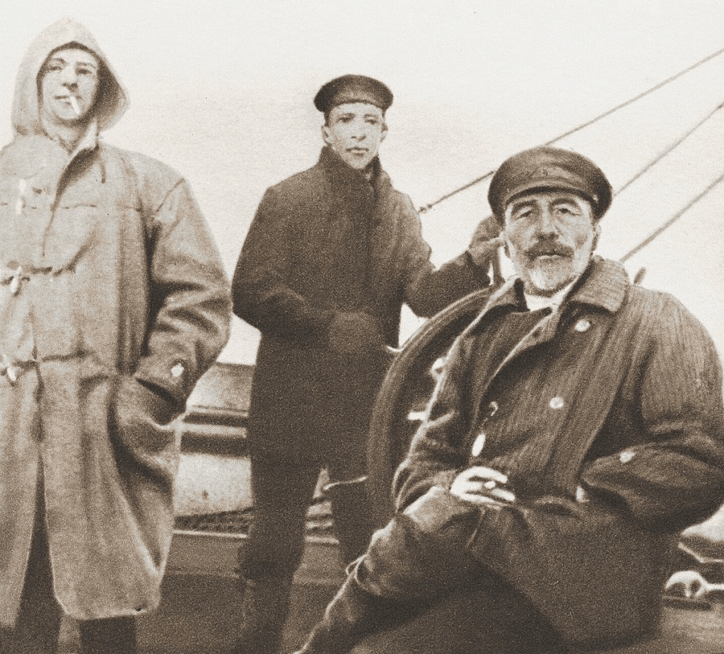 Joseph Conrad (seated) aboard the HMS <em>Ready</em> in 1916 (Widener Library, Harvard University)