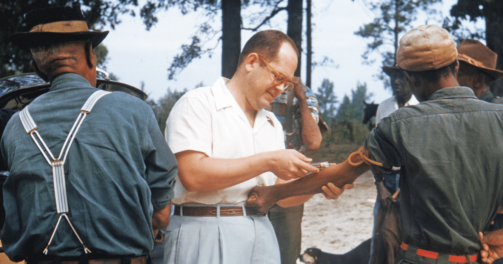 Poor black men, many of them suffering from syphilis, have their blood drawn by a U.S. Public Health Service employee during the Tuskegee study (National Archives at Atlanta)