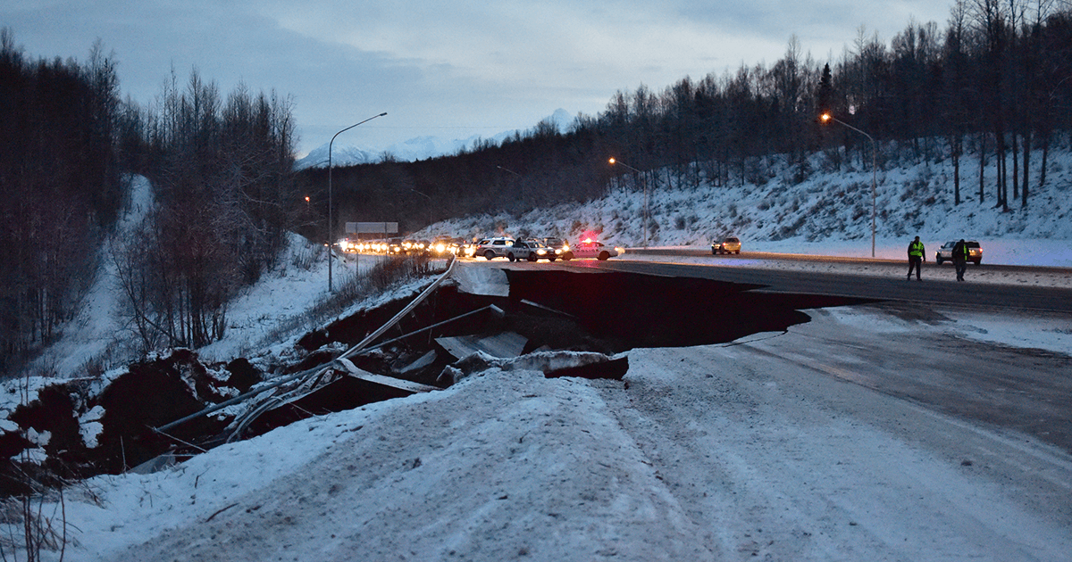 Police stop traffic outside Anchorage, Alaska after a magnitude 7.0 earthquake caused severe damage to the road. (iStock)