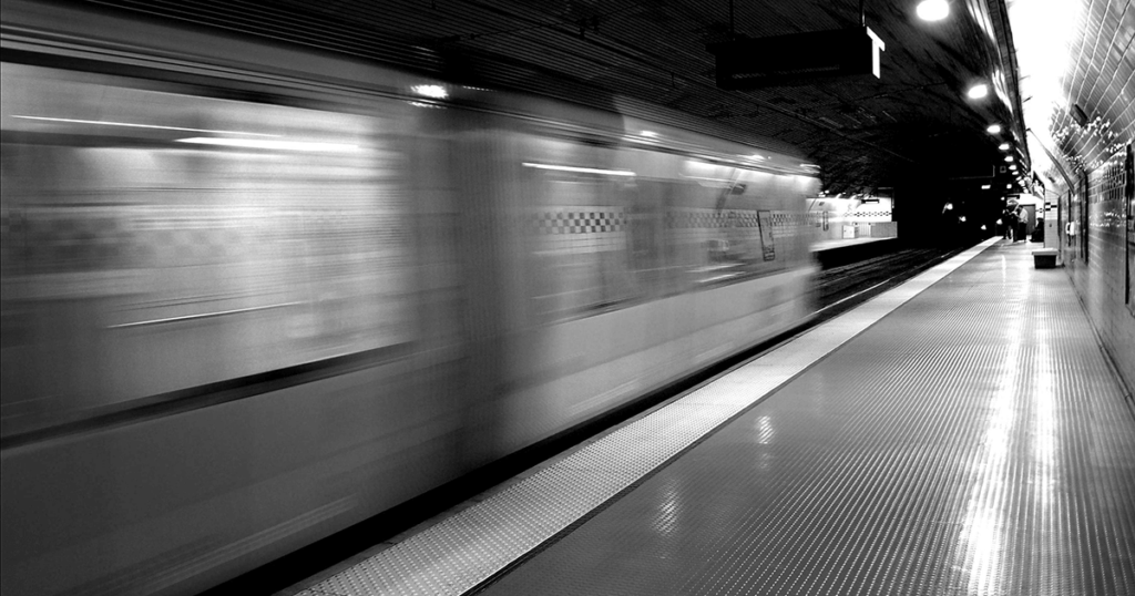 A black and white photograph of a subway car