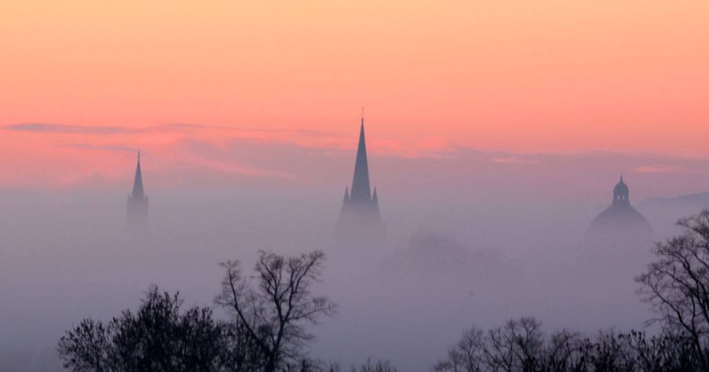 Spires rising out of early morning fog