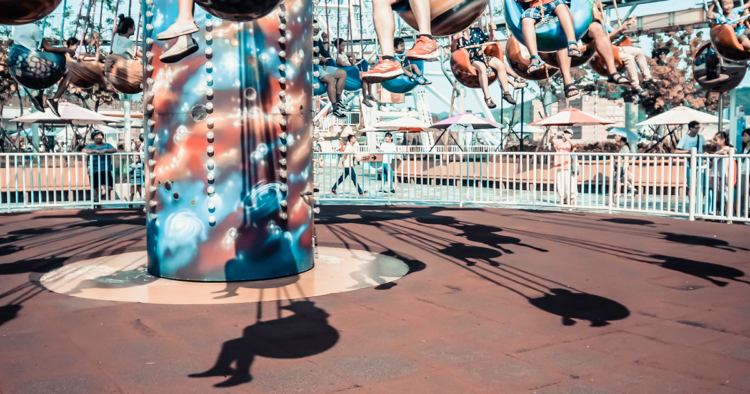 Children on an amusement park swing