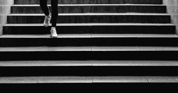 Person walking down stairs, black and white photo