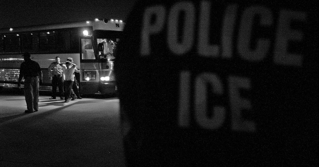 Black and white photo of ICE agents deporting migrants