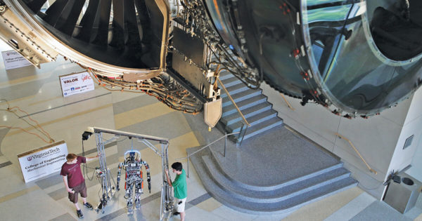 Two students test a robot