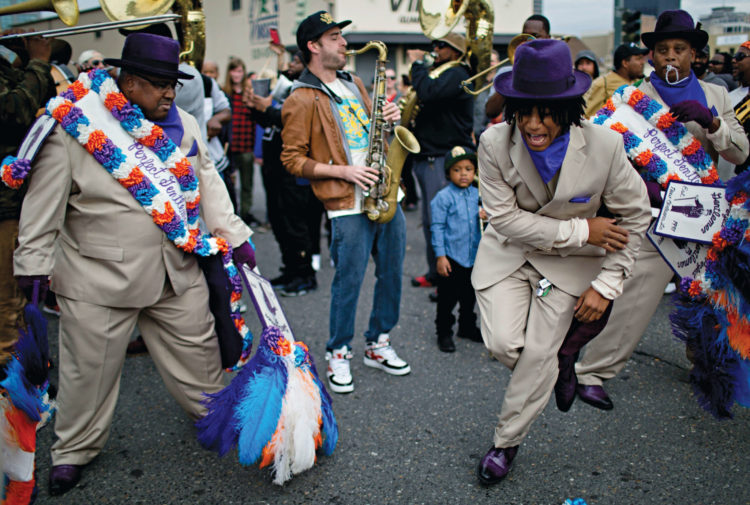 Two men dancing during a second-line parade in New Orleans