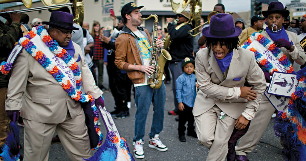 Two men dancing during a second-line parade in New Orleans