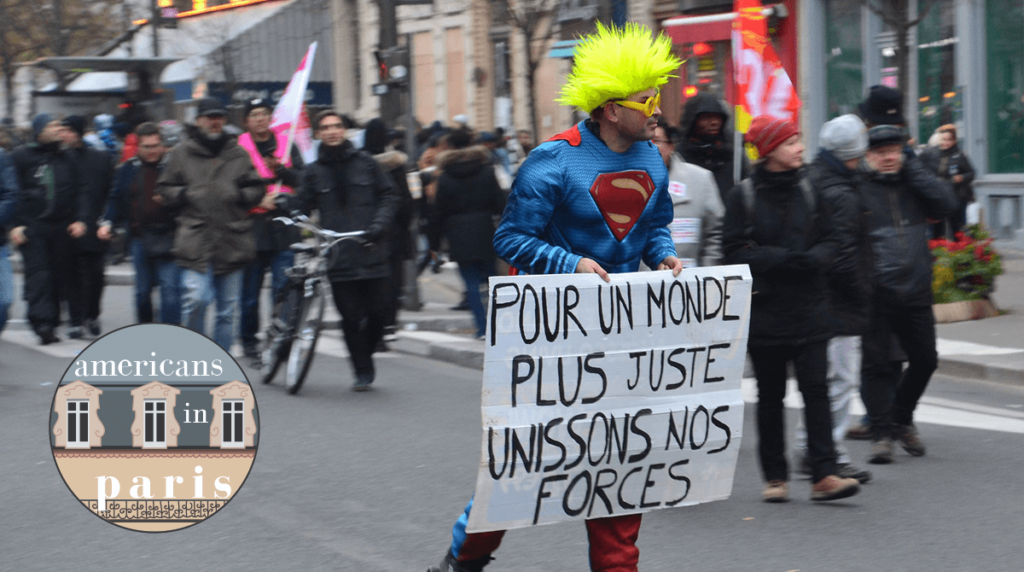 "For a more just world, let us unite our forces": A protester during the December mass strikes and protests in France over pension reform. (Flickr/jmenj)