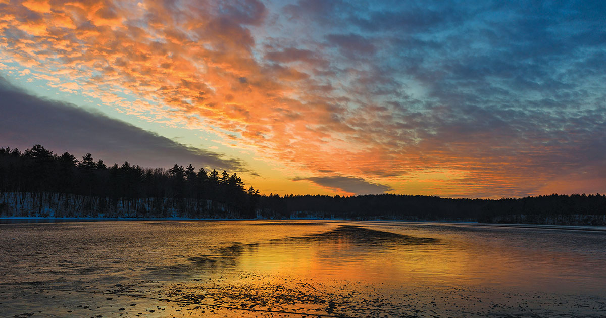 Sunset over Walden Pond. “In Wildness is the preservation of the World,” Thoreau wrote. He lived on Walden from March 1845 until September 1847. (Tetra Images/ Alamy)