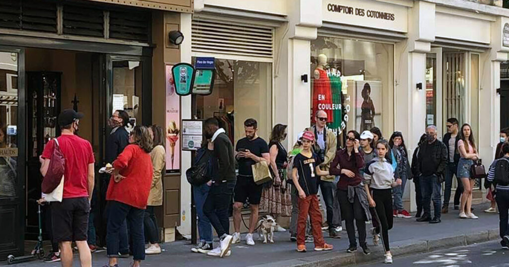 Social distancing is not the main priority for these customers lined up outside an ice cream shop in Paris. (Liz Alderman)
