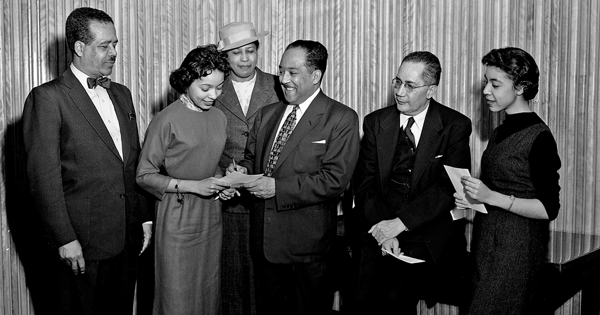 Langston Hughes signs autographs following a lecture at Howard University in 1957 (Washington Area Spark/Flickr)
