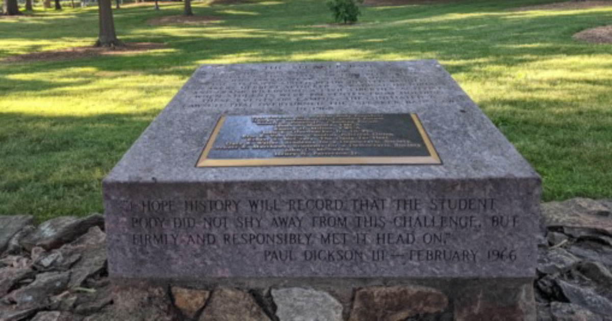The marker commemorating the UNC Speaker Ban controversy is fixed to a stone wall, built in the 19th century by enslaved labor, across which, in 1966, two forbidden speakers addressed throngs of students. In the background is McCorkle Place, the historic heart of UNC-Chapel Hill. Notably absent is Silent Sam, the bronze statue of a Confederate soldier. Installed in 1913 at the height of Jim Crow, he was hurled to the ground by protesters on a summer night in 2018—a year, almost exactly to the date, after the deadly white nationalist rally in Charlottesville. (Sally Greene)