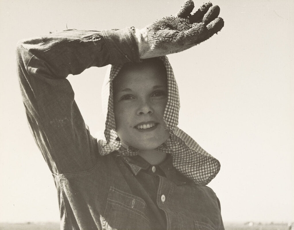 Edison, Kern County, California. <em>Young girl looks up from her work. She picks and sacks potatoes on large-scale ranch,</em> April 11, 1940, gelatin silver print 