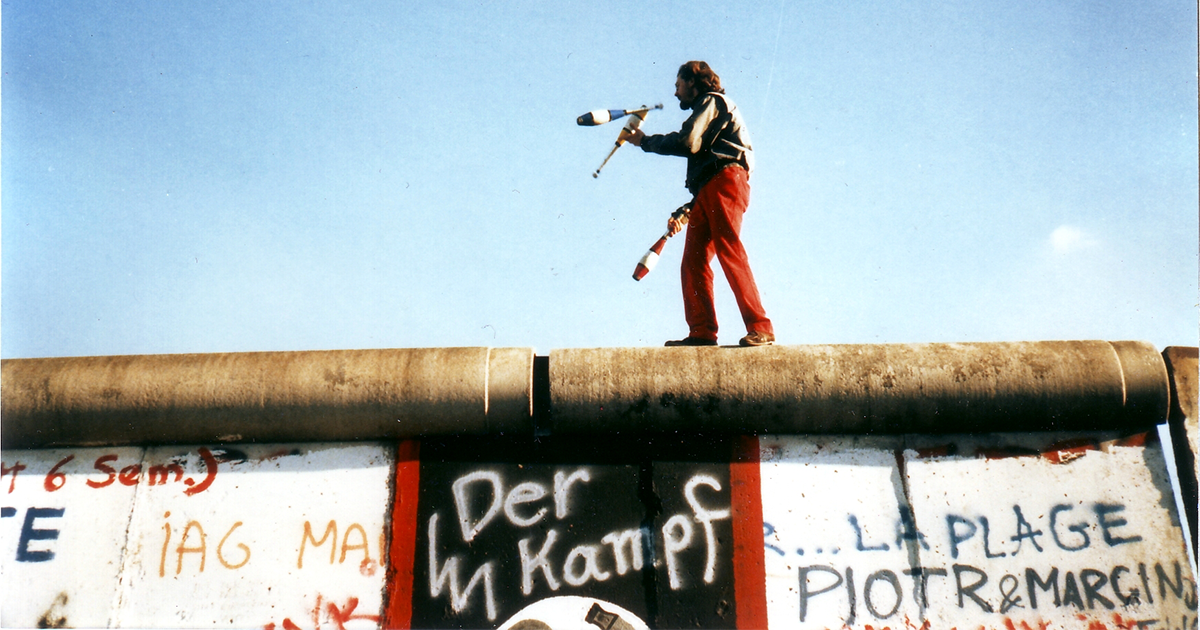 A juggler atop the Berlin Wall, November 1989 (Wikimedia Commons)