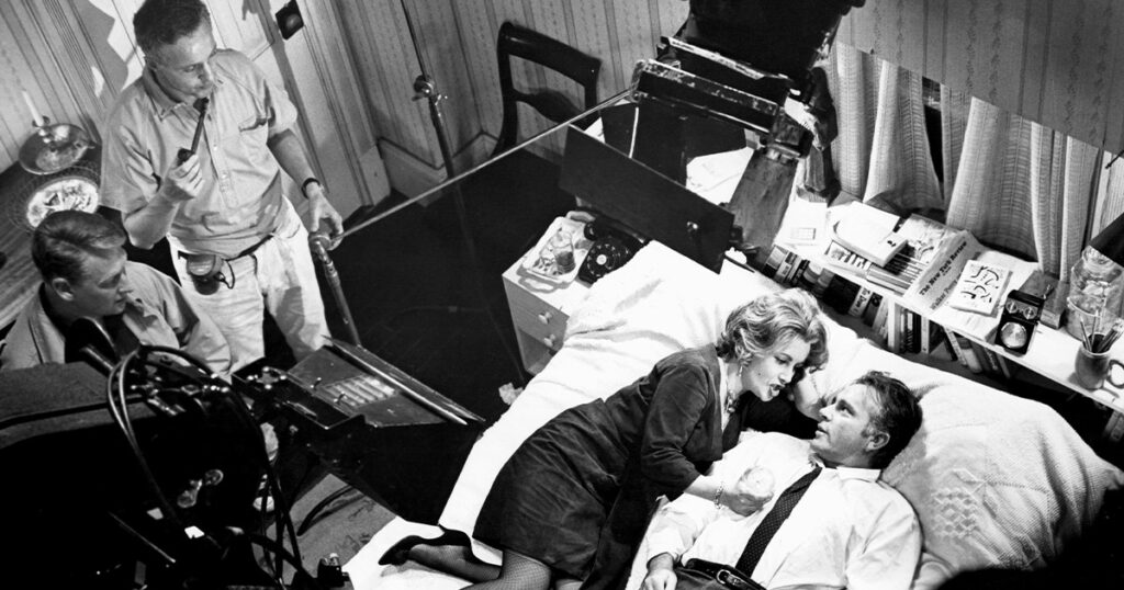Director Mike Nichols (left) and cinematographer Haskell Wexler on the set of <em>Who's Afraid of Virginia Woolf?</em> with Elizabeth Taylor and Richard Burton, 1965